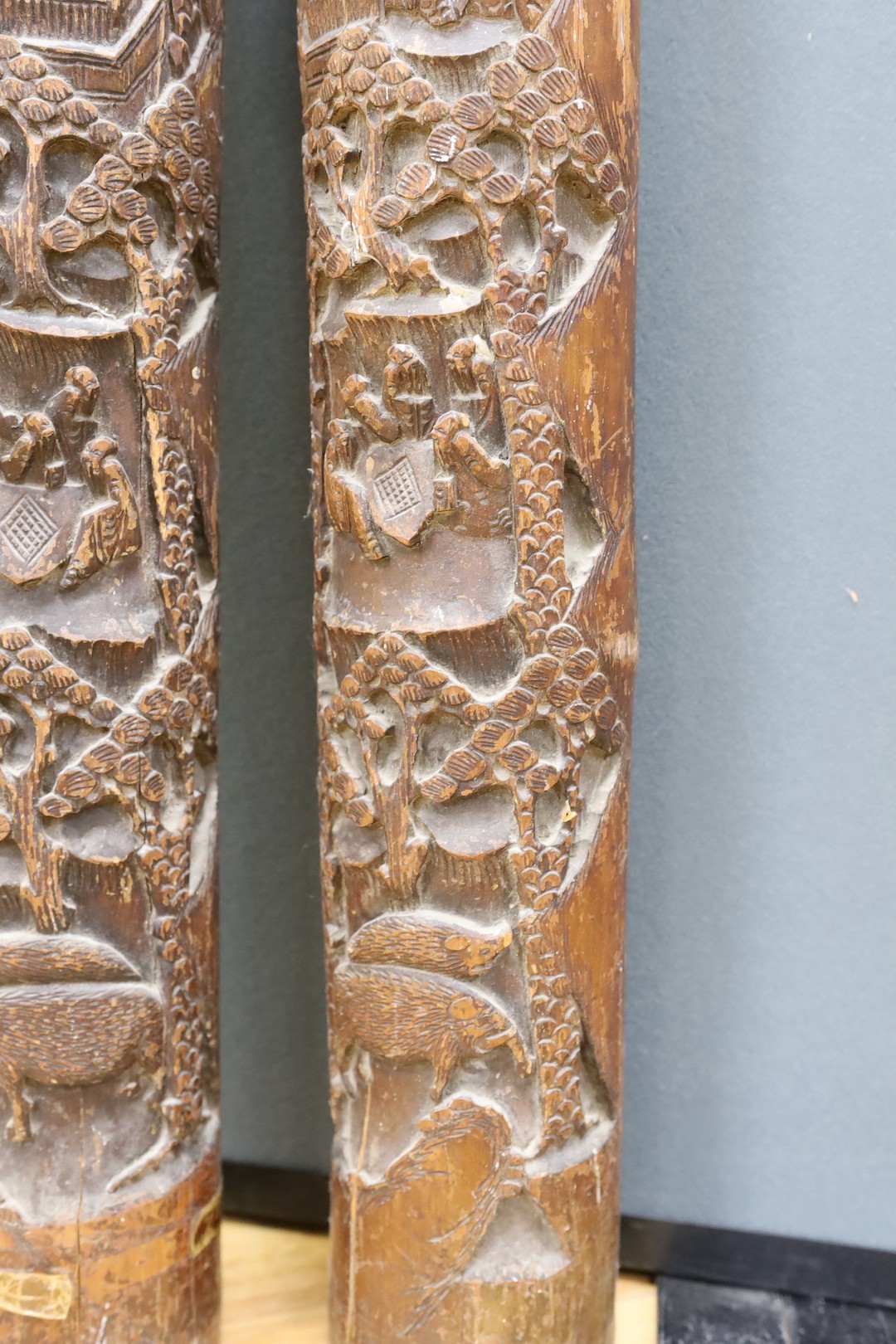 A pair of early 20th century Chinese carved bamboo chutes, 70cm